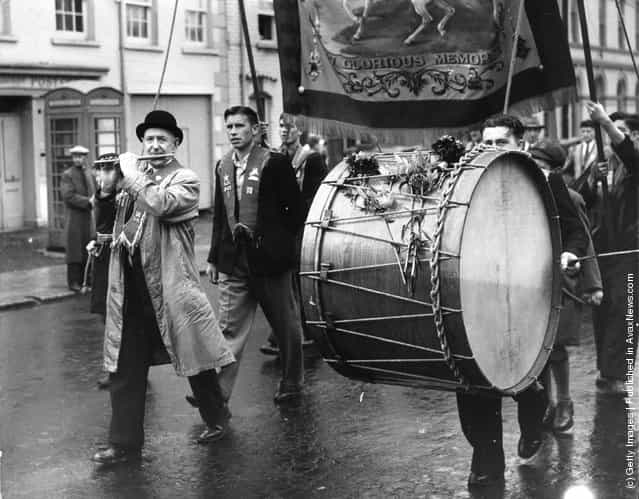 1951: A flautist and lambeg drummer marching with their Orange Lodge in Belfast, Northern Ireland, to celebrate the victory of William III over James II in 1690 and to re-affirm their loyalty to the king and empire