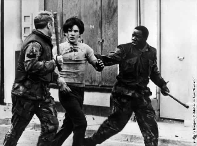 A teenage civilian is arrested by British troops during a civil rights demonstrations in Belfast, 1969