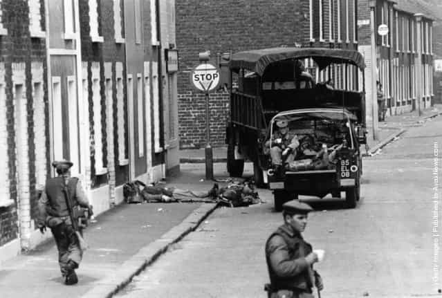 1970: Armed British soldiers impose a curfew on the Falls Road in Belfast