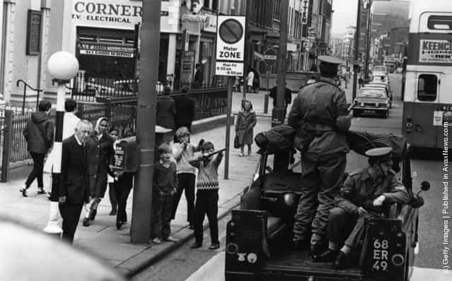 1970: Children mocking an Army patrol in Belfast