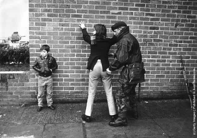1971: A British soldier searching a Belfast teenager