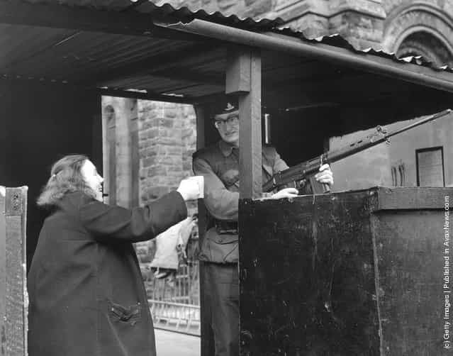 1971: A woman offers a cup of tea to a soldier manning a check point in a Belfast street