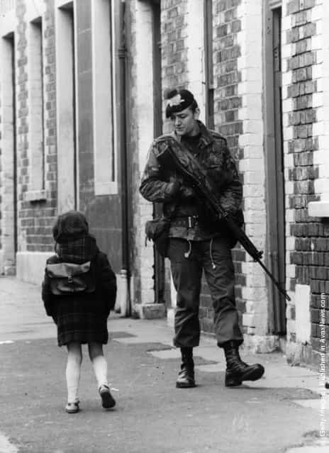 1981: A Belfast girl chats to a soldier out patrolling the streets in the Falls Road area