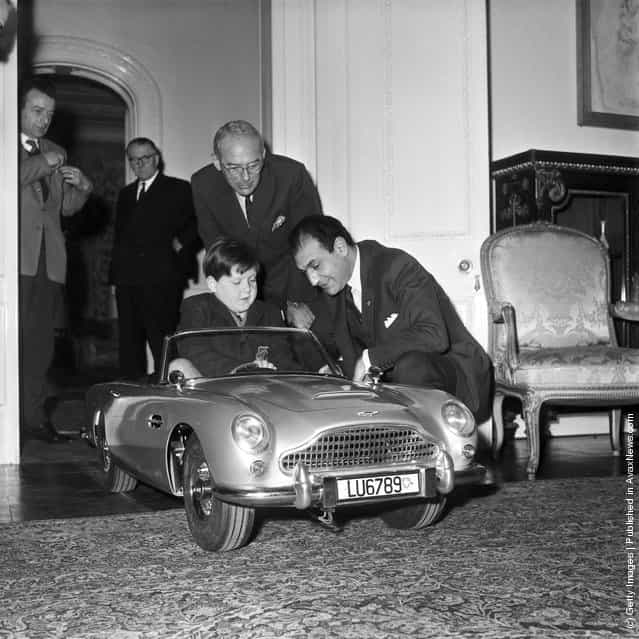 Seven-year old Ian Heggie, the son of Aston Martins Deputy Managing Director, test drives a toy Aston Martin DB5, at the Iranian Embassy in London, 20th December 1966
