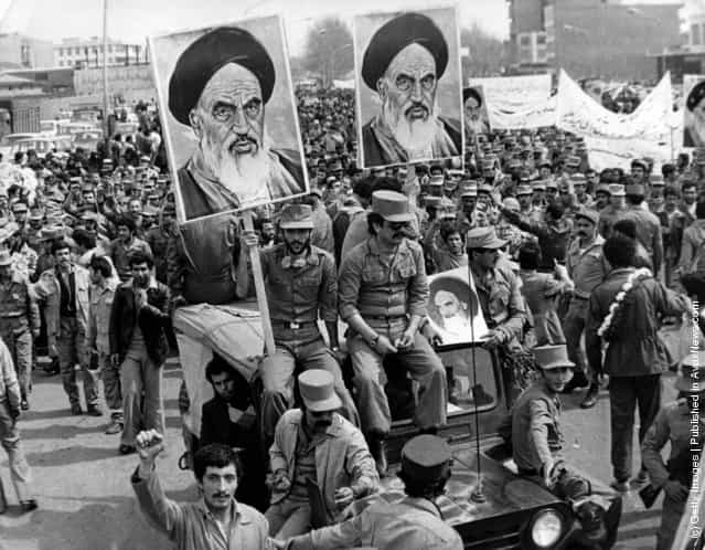 The Iranian Islamic Republic Army demonstrates in solidarity with people in the street during the Iranian revolution. They are carrying posters of the Ayatollah Khomeini, the Iranian religious and political leader, 1979