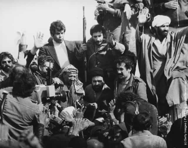 A television crew films PLO Chairman Yasser Arafat (centre, left) with Iranian revolutionaries at a cemetery in Tehran, February 1979. Arafat was the first foreign dignitary to visit the post-revolutionary Iran of Ayatollah Khomeini