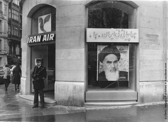 1979: A poster of the Iranian Muslim leader Ayatollah Ruhollah Khomeini (1900 - 1989) in the window of Iran Air in Paris, France