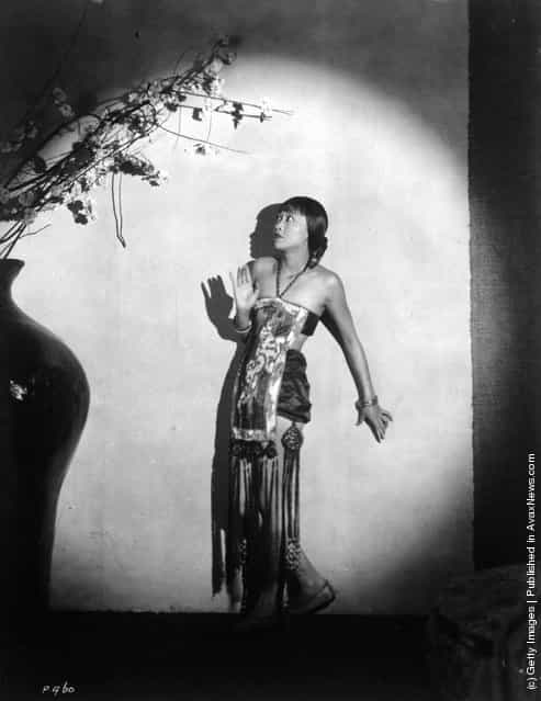 circa 1930: Chinese-American actress Anna May Wong (1907 - 1961) surrounded by ominous shadows