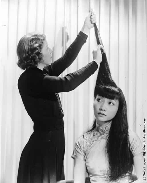 1930: American-Chinese actress Anna May Wong (1907 - 1961) having her hair done