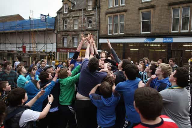 Youths tussle for the leather ball during the annual Fastern Eve Handba event in Jedburghs High Street in the Scottish Borders in Jedburgh