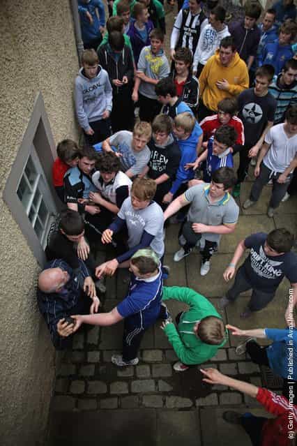 Youths tussle for the leather ball during the annual Fastern Eve Handba event in Jedburghs High Street in the Scottish Borders in Jedburgh