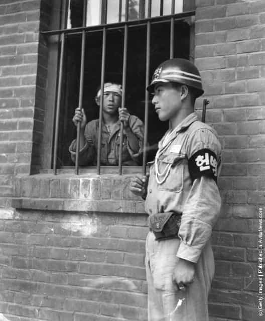 A South Korean soldier on guard at Taegu mission school, which served as a POW camp during the Korean War
