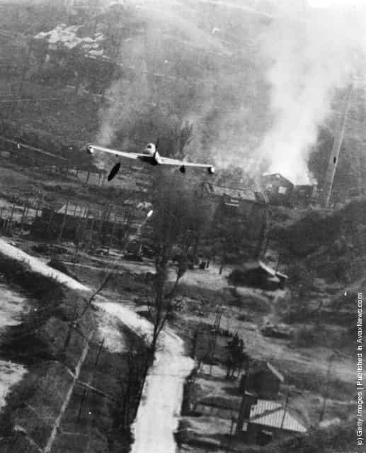A US F-80 Shooting Star making a low-level attack with a napalm bomb on a storage centre at Suan, south-east of Pyongyang, during the Korean War, 1952