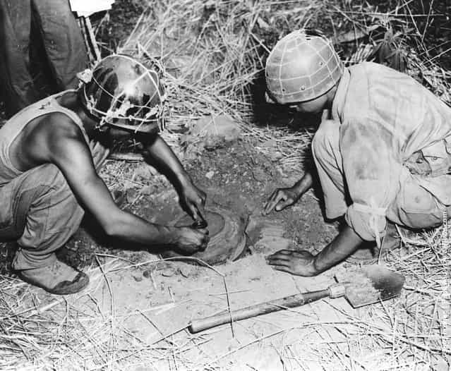 Two soldiers of the 1st Division of the South Korean Army laying anti-tank mines during the Korean War, August 1950