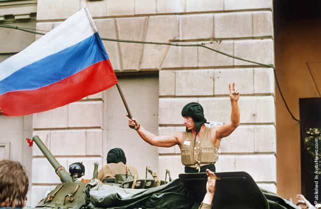 A soldier waves a Russian flag from the top of his tank as armored units leave their positions in Moscow following the collapse of the military coup against president Gorbachev on August 21, 1991. Coup leaders fled the capital and president Gorbachev was rumored to be returning soon