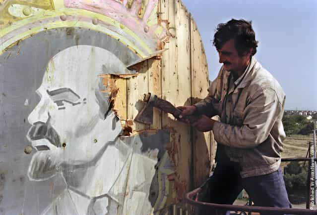 A Baku resident uses an axe to hack apart a placard showing a portrait of Russian Bolshevik revolutionary leader Vladimir Lenin, on September 21, 1991. Azerbaijan was proclaimed a Soviet Socialist Republic by Soviet Union in 1920. The Azeri National Council voted for its declaration of independence in 1991