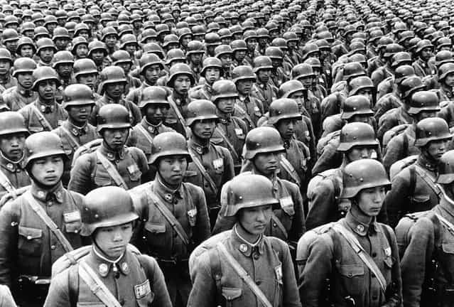 Entering their fourth year of war against Japan, Chinese military forces were strengthening their air force, producing their own armaments, and training their officers in the methods of modern war. Here, Chinese cadets in full battle dress, they favor the German type of steel helmet, on parade somewhere in China, on July 11, 1940
