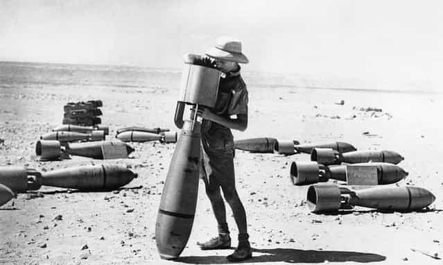 This armorer of the R.A.F.'s middle east command prepares a bomb for its mission against the Italian forces campaigning in Africa. This big bomb is not yet fused, but when it is it will be ready for its deadly work. Photo taken on October 24, 1940