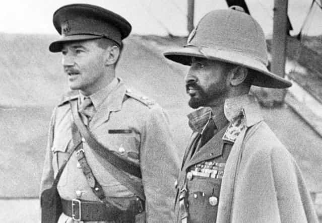 Haile Selassie (right), exiled Emperor of Ethiopia, whose empire was absorbed by Italy, returns with an Ethiopian army recruited to aid the British in Africa, on February 19, 1941. Here, the emperor inspects an airport, an interpreter at his side. On May 5, 1941, after the Italians in Ethiopia were defeated by Allied troops, Selassie returned to Addis Ababa, and resumed his position as ruler