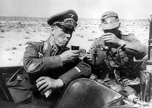 Field Marshal Gen. Erwin Rommel, commander of the German Afrika Korps, drinks out of a cup with an unidentified German officer as they are seated in a car during inspection of German troops dispatched to aid the Italian army in Libya in 1941