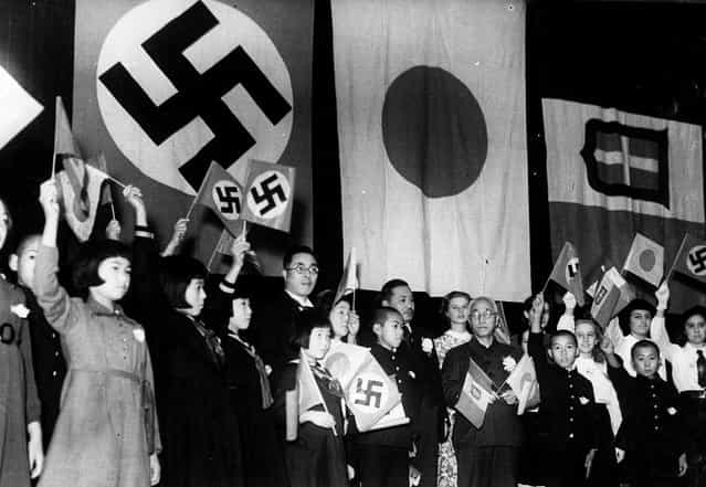 Children of Japan, Germany, and Italy meet in Tokyo to celebrate the signing of the Tripartite Alliance between the three nations, on December 17, 1940. Japanese education minister Kunihiko Hashida, center, holding crossed flags, and Mayor Tomejiro Okubo of Tokyo were among the sponsors