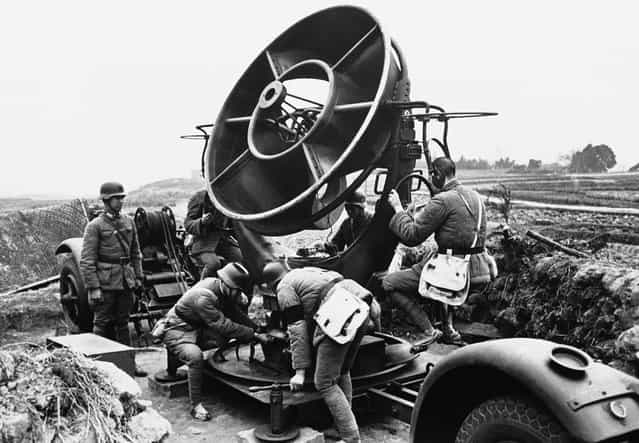 Chinese soldiers man a sound detector which directs the firing of 3-inch anti-aircraft guns, around the city of Chongqing, China, on May 2, 1941