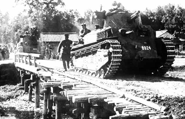 A Japanese tank passes over an emergency bridge, somewhere in China, on June 30, 1941
