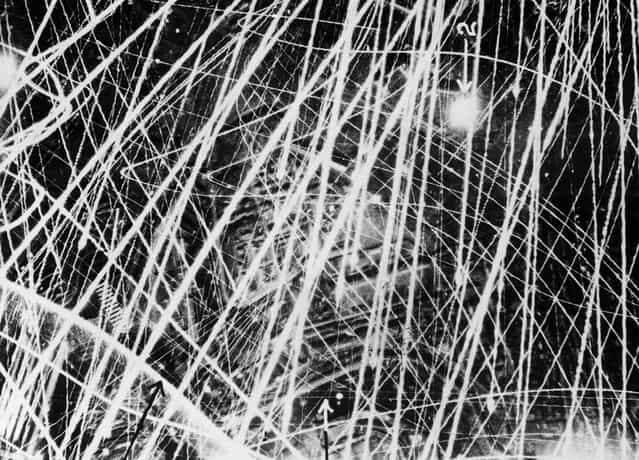 This photograph was taken on Jan. 31, 1941, during a nigthtime air raid carried out by the Royal Air Force above Brest, France. It gives a graphic impression of what flak and anti-aircraft fire looks like from the air. In the period of three to four seconds during which the shutter remained open, the camera clearly captured the furious gunfire. The fine lines of light show the paths of tracer shells, and the broader lines are those of heavier guns. Factories and other buildings can be seen below