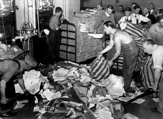 U.S. Postal employees feed 17 tons of reading matter, labeled by postal authorities as propaganda, into a furnace in San Francisco, California, on March 19, 1941. The bulk of the newspapers, books, and pamphlets came from Nazi Germany and some from Russia, Italy and Japan