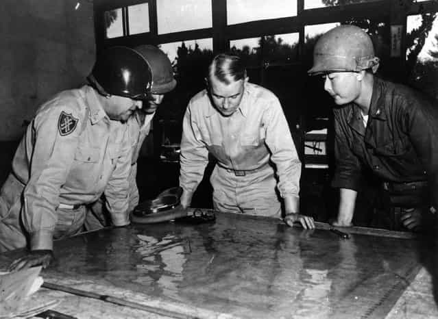 United States Army Chief of Staff General Collins studying a map of the front line during the battle for Korea, with Lieutenant General Walker, Brigadier General Farrell and Korean Brigadier General Paik, 1950. (Photo by Keystone)