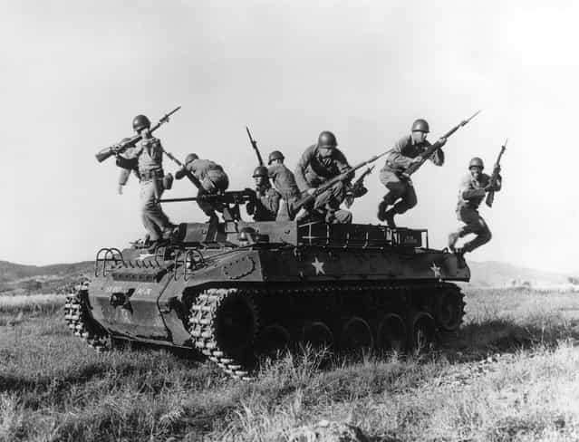 American soldiers leaping from an armoured personnel carrier during exercises in Korea, 17th March 1954. (Photo by Three Lions)