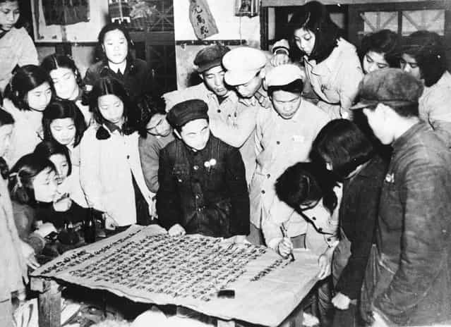 Workers in a Peking uniform and bedding factory writing a letter to Mao Tse Tung to express their determination to increase production following the intervention of the Communist Volunteers in the Korean War, December 1950. (Photo by Keystone)