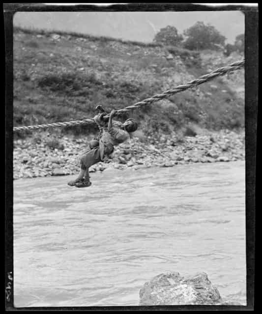 Man on Rope Bridge. China, Zagunao, 1917-1919. (Photo by Sidney David Gamble)