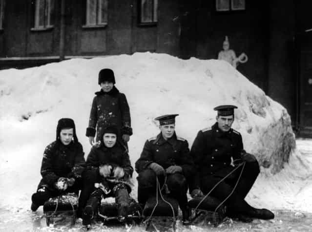 Royal children play in the snow outside the Anichkov Palace, Petrograd, residence of their grandmother, Empress Marie Feodorovna, circa 1913. They are nephews of Tsar Nicholas II, and sons of Grand Duke Alexander Mikhailovich and Grand Duchess Xenia Alexandrovna of Russia. From left to right in front are: Prince Rostislav Alexandrovitch, Prince Dmitri Alexandrovitch, Prince Nikita Alexandrovitch, and Prince Andrei Alexandrovitch and behind them stands Prince Vasili Alexandrovitch.
