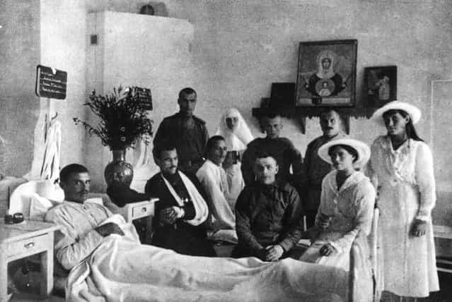 Grand Duchess Marie Nikolaievna (1899–1918) (right), and her sister Grand Duchess Anastasia Nikolaievna (1901–1918), two of the daughters of the Emperor Nicholas II, visit patients in the hospital on their estate, circa 1915.