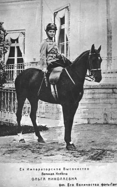 Olga, eldest daughter of Emperor Nicholas II, later Grand Duchess of Russia, on a horse outside a palace, circa 1910.