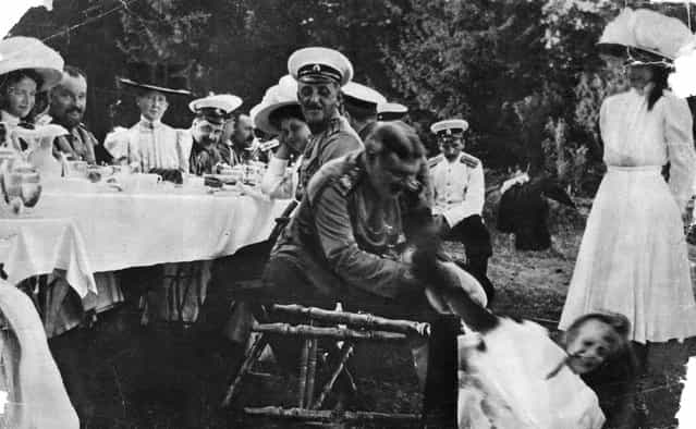Outdoor family dinner, circa 1910.