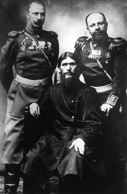 Russian peasant and mystic Grigory Yefimovich Rasputin (1869–1916), centre, former peasant and self-styled holy man, sitting between two military men in uniform, 1910.