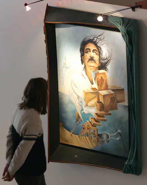 A visitor watches for a painting of Salvador Dali at the Salvador Dali exhibition [Die Ausstellung] on March 19, 2008 in Berlin, Germany. The spanish painter Salavdor Dali was a skilled draftsman, best known for the striking and bizarre images in his surrealist work. His painterly skills are often attributed to the influence of Renaissance masters. His best known work, The Persistence of Memory, was completed in 1931. (Photo by Andreas Rentz)