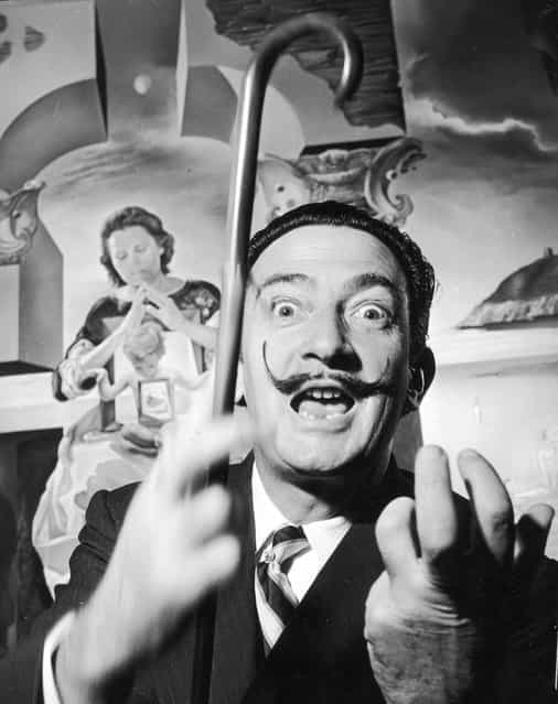 Spanish surrealist artist Salvador Dali (1904–1989) in London with one of his paintings entitled [The Madonna of Port Lligat], December 1951. (Photo by George Konig/Keystone Features)