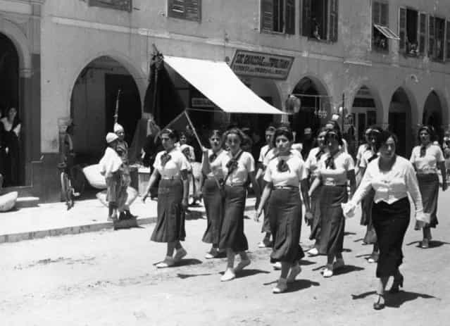 Black shirts are not worn, but these girls are members of the Italian Fascist organisation, taking part in a parade in Tripoli on review day, 1935. (Photo by Baron)