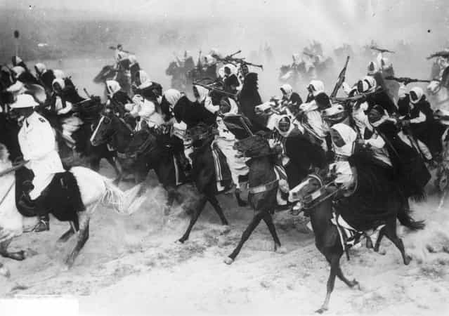 Libyan cavalrymen charging across the sand on horseback during a military display. 20th December 1939. (Photo by Keystone)