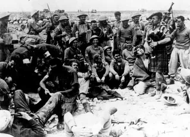 Soldiers being entertained by an officer playing the bagpipes at their camp in Libya, North Africa, during the Second World War, circa 1940. (Photo by Keystone)