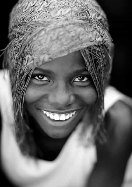 [Caroline, Mudimba girl smile – Angola. Mudimba young girl dressed for a wedding. Most of the women were wearing some clothes as it was a christian wedding, but some stayed in their tribal clothes: topless!]. (Eric Lafforgue)