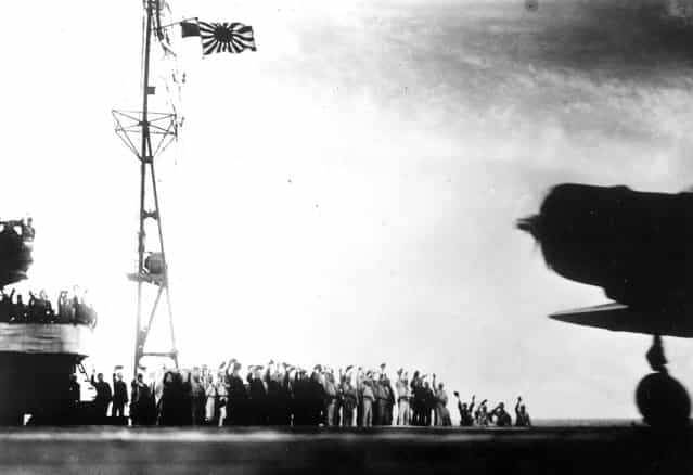 This photograph, from a Japanese film later captured by American forces, is taken aboard the Japanese aircraft carrier Zuikaku, just as a Nakajima [Kate] B-5N bomber is launching off deck for the second wave of the attack on Pearl Harbor on December 7, 1941. (Photo by Associated Press)