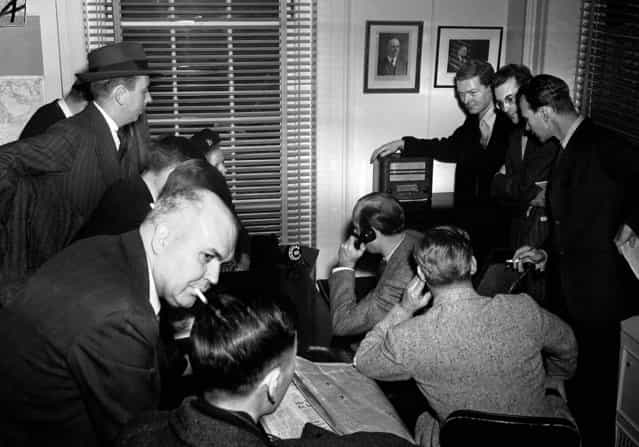 White House reporters listen to the radio in the White House press room as Japan declares war on the U.S., December 7, 1941. (Photo by Associated Press)