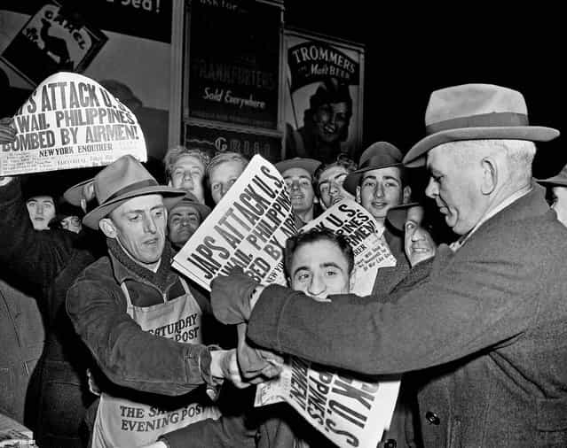 Papers are sold at Times Square in New York City on December 7, 1941, announcing that Japan has attacked U.S. bases in the Pacific. (Robert Kradin/Associated Press)