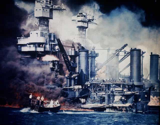 A small boat rescues a USS West Virginia crew member from the water after the Japanese bombing of Pearl Harbor. (Photo by Associated Press)