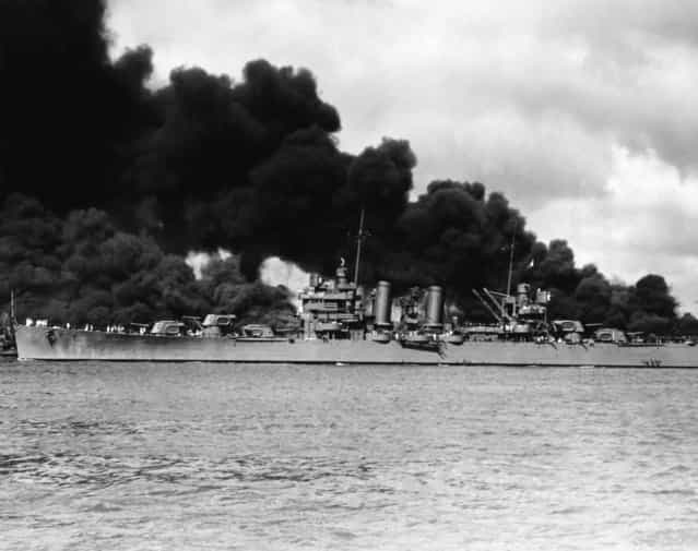 The American light cruiser USS Phoenix passing the burning USS West Virginia and USS Arizona, during the Japanese attack on Pearl Harbor, 7TH December 1941. (Photo by Hulton Archive/Getty Images)
