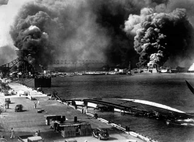 7th December 1941: A general view of Pearl Harbour (Pearl Harbor) after it had been attacked by the Japanese. Smoke pours from USS Shaw (right centre) whilst the minelayer USS Oglana lies capsized in the foreground. (Photo by Keystone/Getty Images)